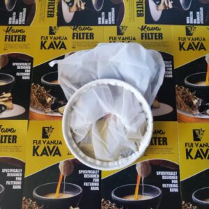 A close up of a cup on top of some coffee filters