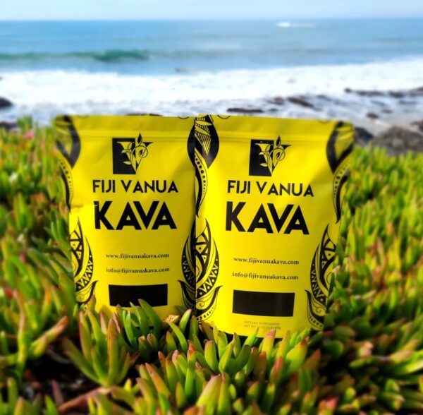 Two bags of kava sitting in the grass.