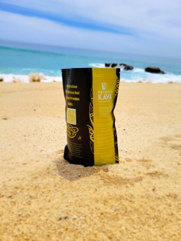 A bag of coffee sitting on the beach.