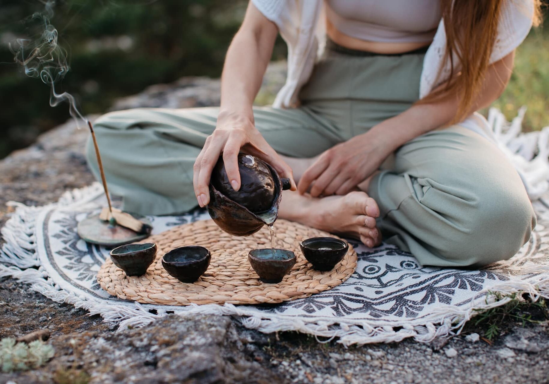Image 1 10.14.25 A young beautiful woman performs a Chinese tea ceremony in the mountains at sunset.