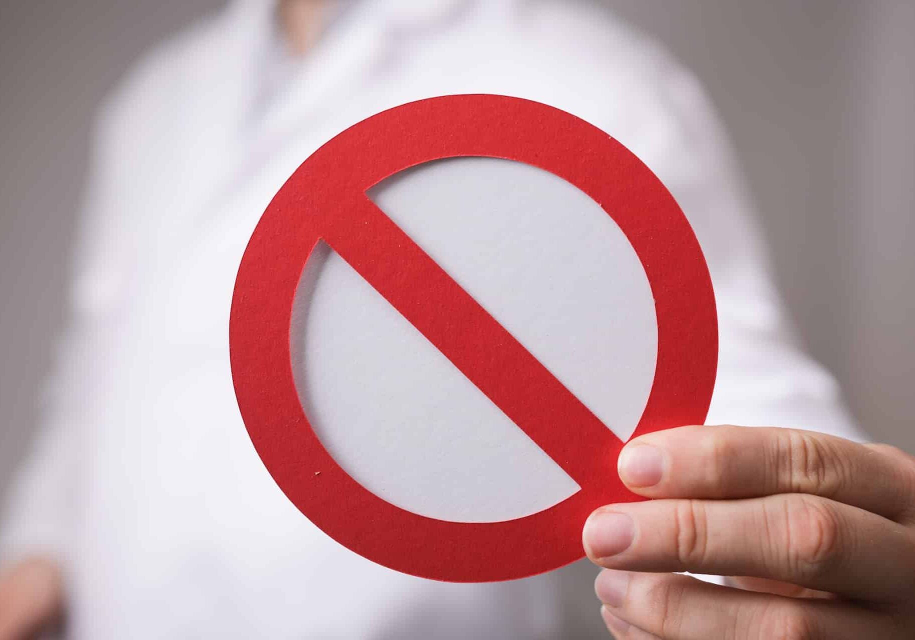Red stop sign in the hands of a doctor The red stop sign in the hands of a doctor